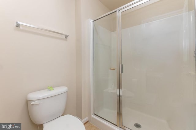 bathroom with toilet and a shower with door