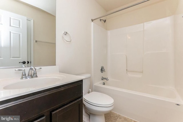 full bathroom featuring washtub / shower combination, vanity, toilet, and tile patterned floors