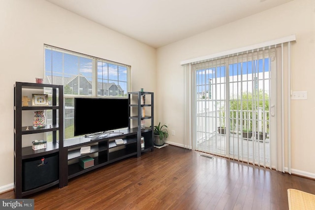 living room with dark hardwood / wood-style flooring