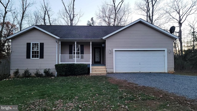 ranch-style house featuring a garage, covered porch, and a front lawn