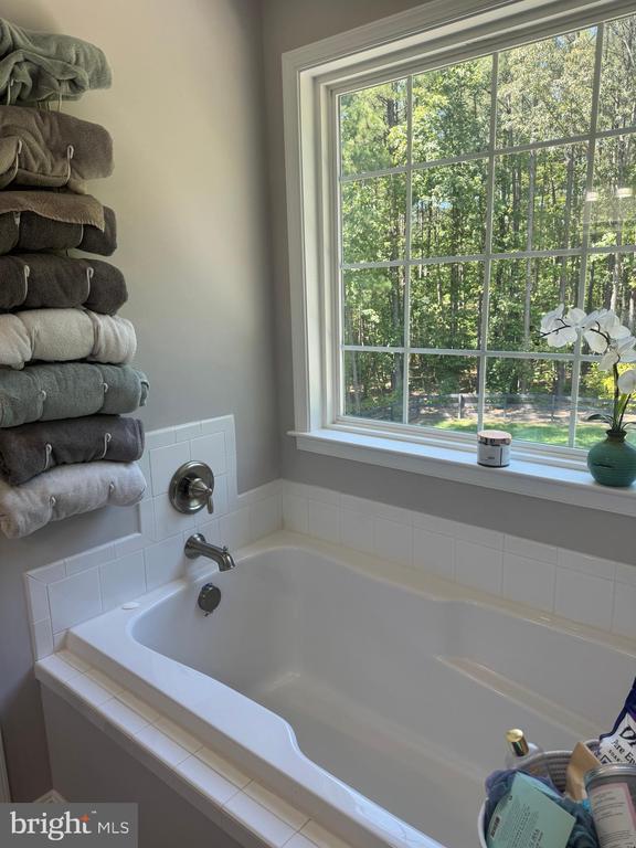 bathroom with tiled bath