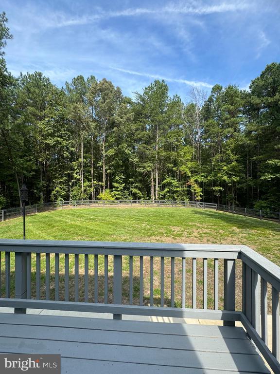 wooden terrace with a yard