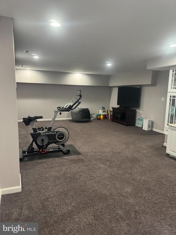 workout area featuring dark colored carpet