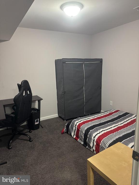 bedroom featuring dark colored carpet