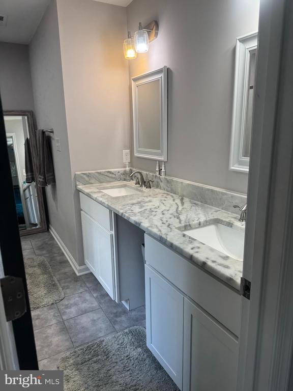 bathroom with vanity and tile patterned floors