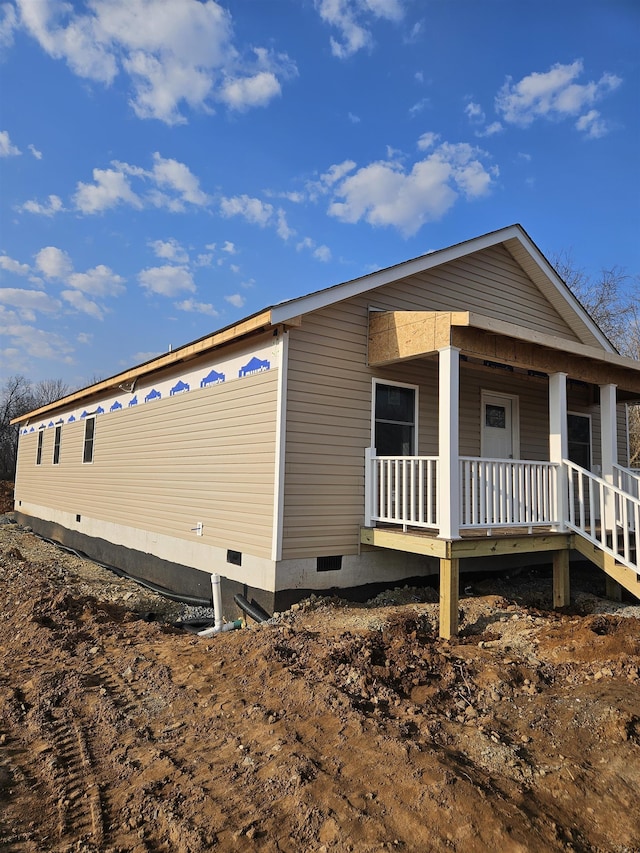 view of property exterior with a porch