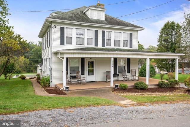 view of front of home featuring a front yard and covered porch