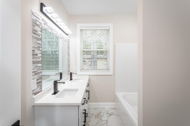 bathroom featuring vanity and a bathtub