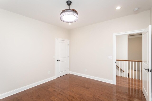 unfurnished room featuring dark wood-type flooring