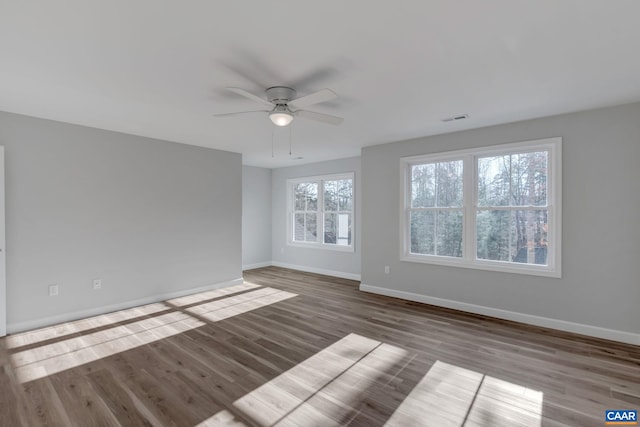 unfurnished room with dark wood-type flooring and ceiling fan