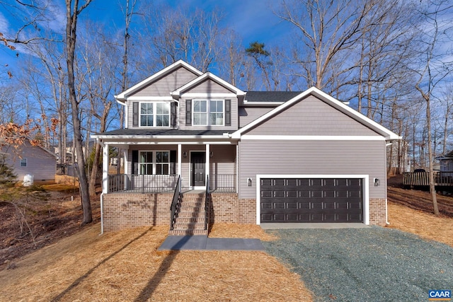 view of front facade with a porch, a garage, and a front lawn