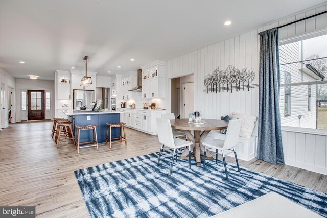 dining space with light wood-type flooring