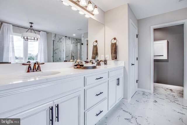 bathroom with a shower with door, vanity, and a notable chandelier