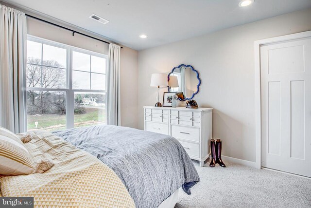 bedroom with light colored carpet