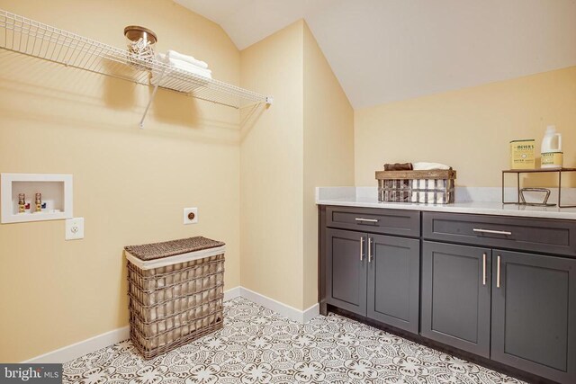 washroom featuring washer hookup, cabinets, and hookup for an electric dryer