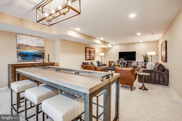 recreation room with light carpet and brick wall