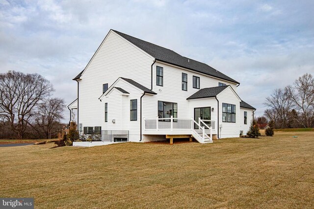 rear view of house with a patio and a yard