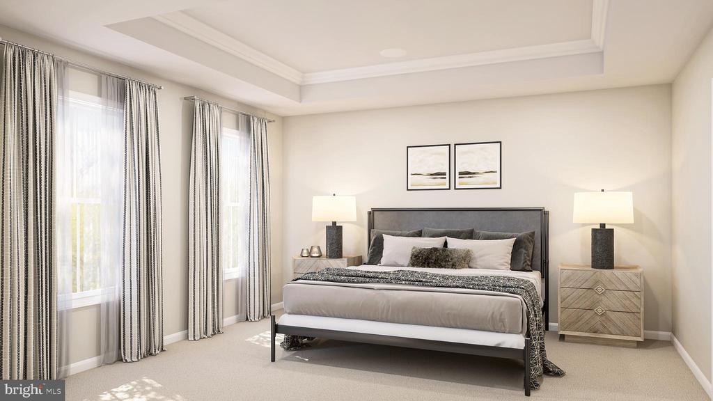 bedroom with ornamental molding, a raised ceiling, and carpet