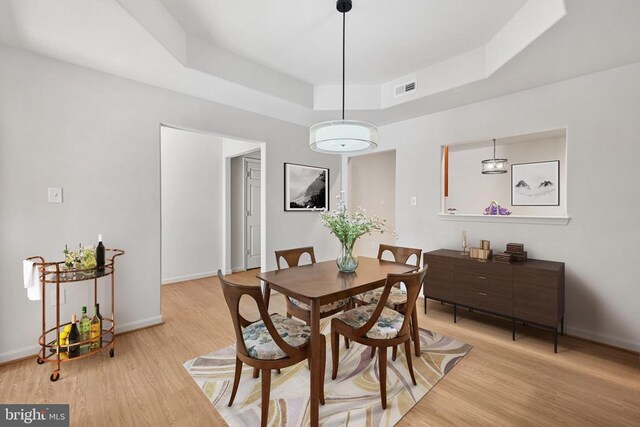 kitchen featuring sink, light hardwood / wood-style flooring, appliances with stainless steel finishes, light stone countertops, and decorative light fixtures