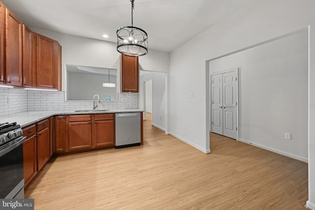 kitchen featuring sink, backsplash, light hardwood / wood-style flooring, and stainless steel appliances