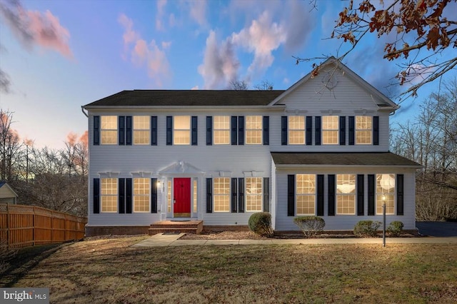 view of front of home featuring a front lawn and fence