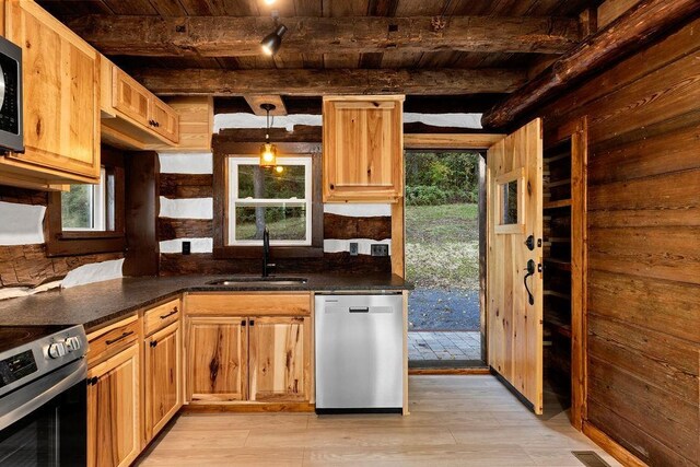 kitchen featuring appliances with stainless steel finishes, sink, dark stone counters, hanging light fixtures, and beam ceiling