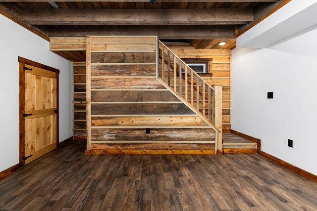 stairs with hardwood / wood-style flooring and beamed ceiling