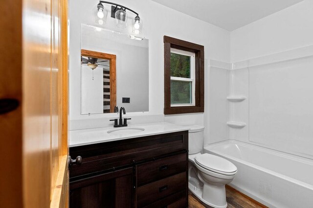 full bathroom with washtub / shower combination, vanity, and toilet