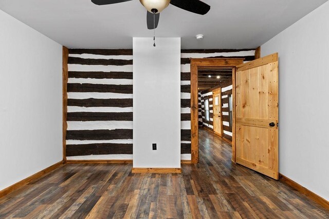 spare room with dark hardwood / wood-style flooring and ceiling fan