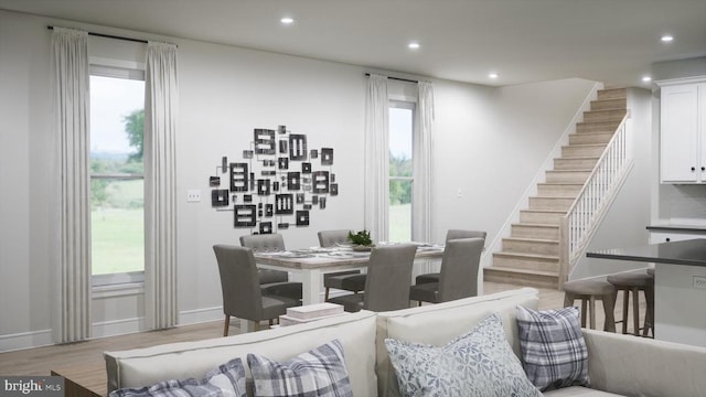 dining area featuring recessed lighting, light wood finished floors, and stairs