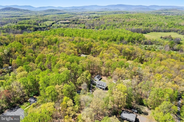 drone / aerial view with a mountain view and a wooded view