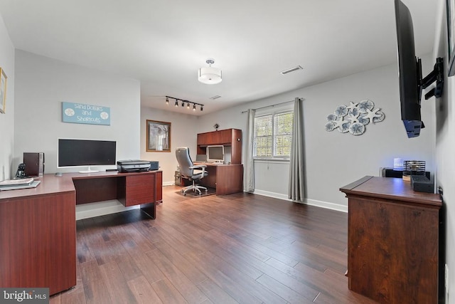 office space featuring track lighting, dark wood-style floors, baseboards, and visible vents