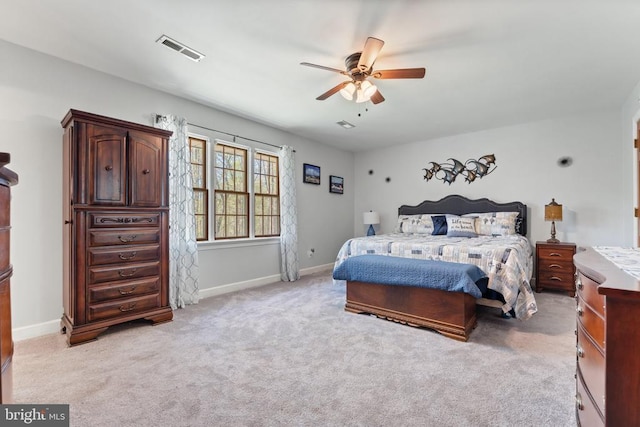 bedroom featuring light colored carpet, baseboards, a ceiling fan, and visible vents
