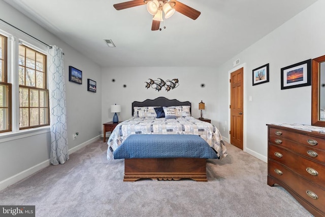 bedroom featuring light carpet, baseboards, visible vents, and ceiling fan