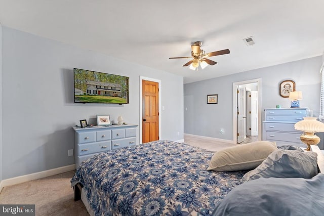 bedroom featuring light colored carpet, baseboards, a ceiling fan, and visible vents