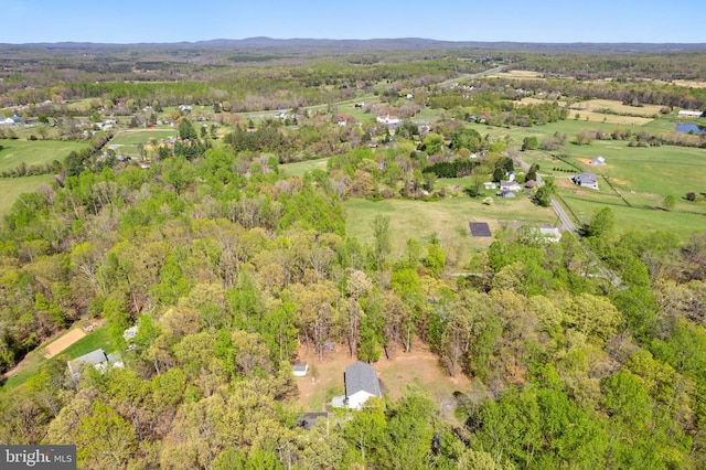 birds eye view of property with a view of trees