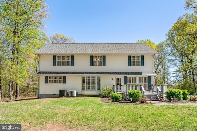rear view of property featuring a lawn, crawl space, and a deck