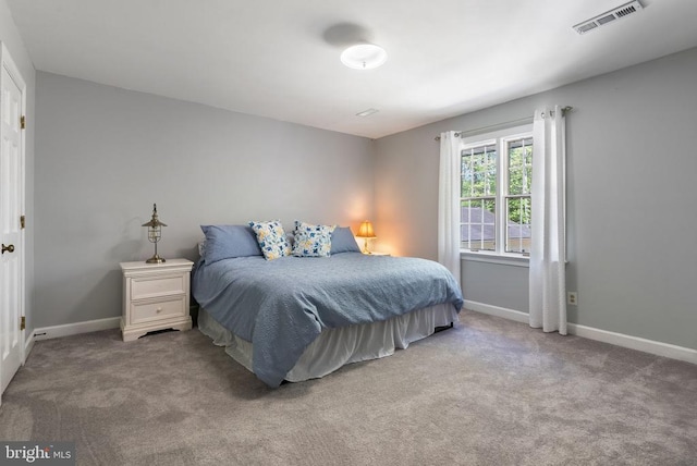 bedroom featuring baseboards, visible vents, and carpet flooring
