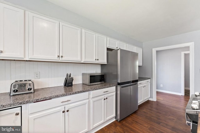 kitchen with baseboards, white cabinetry, dark wood-style floors, and stainless steel appliances