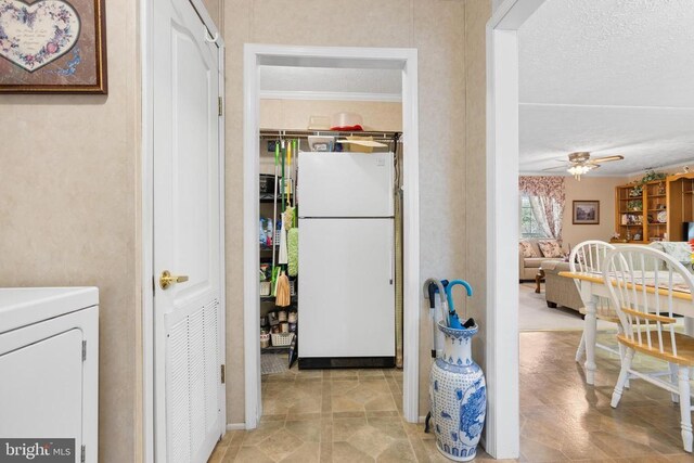 interior space featuring washer / clothes dryer, a textured ceiling, and ceiling fan