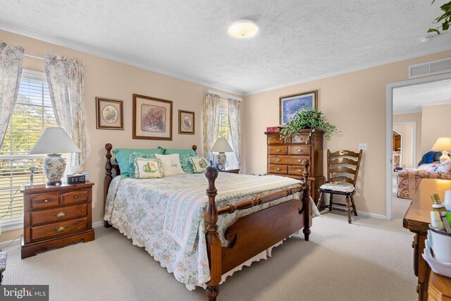 bedroom with light colored carpet, multiple windows, and a textured ceiling