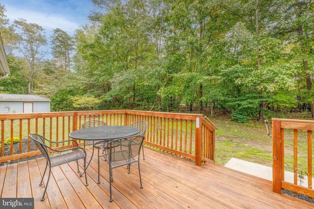 wooden deck featuring a storage unit