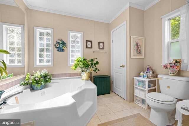 bathroom featuring crown molding, a tub to relax in, and toilet