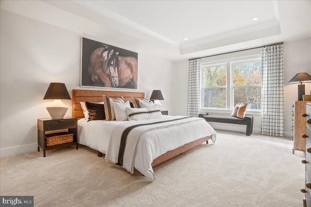 carpeted bedroom with crown molding and a raised ceiling