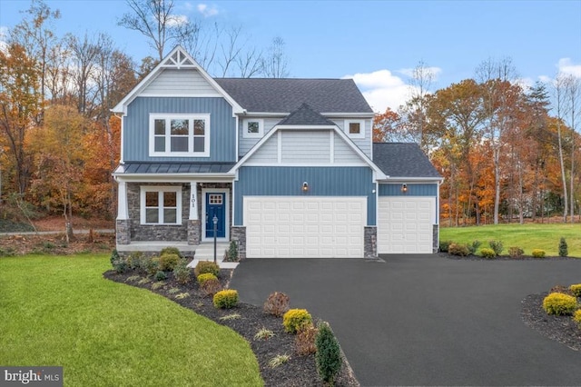 craftsman-style home featuring a garage and a front yard