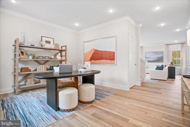 office with ornamental molding and light hardwood / wood-style floors