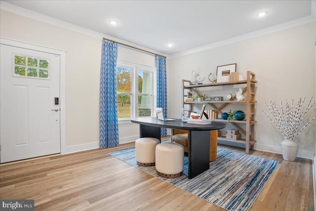 office space with ornamental molding and light hardwood / wood-style floors