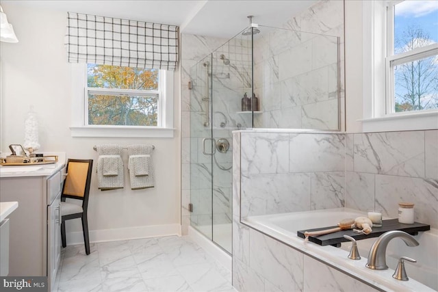 bathroom featuring vanity, shower with separate bathtub, and a wealth of natural light