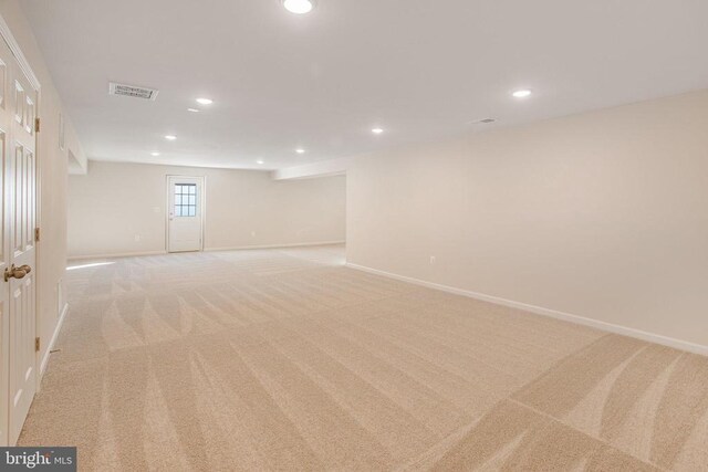 basement featuring light carpet