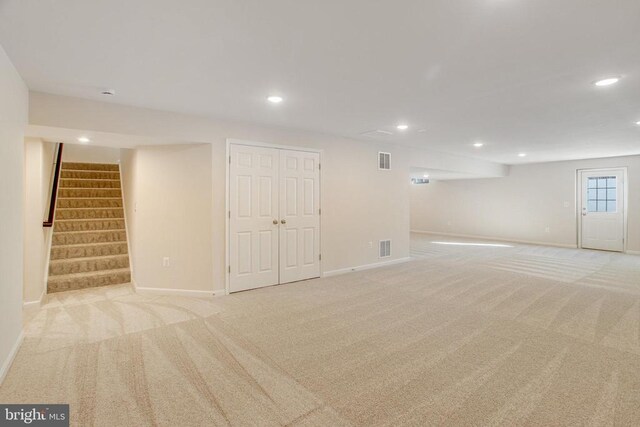 basement featuring light carpet